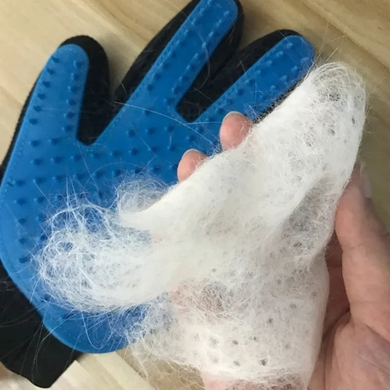 Blue grooming glove with collected pet hair on a wooden surface