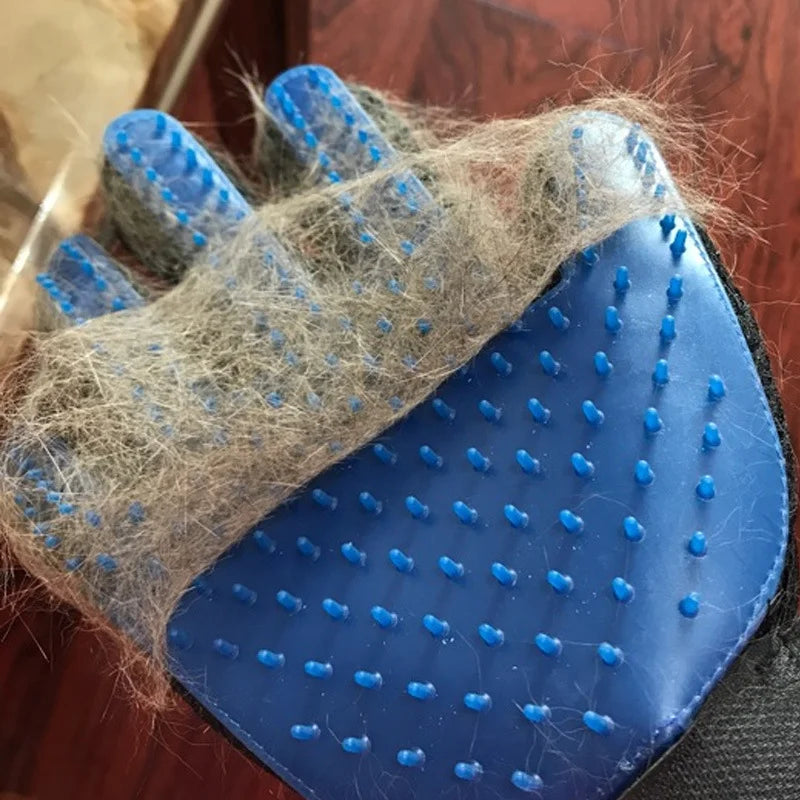 Blue grooming glove with pet hair on a wooden surface