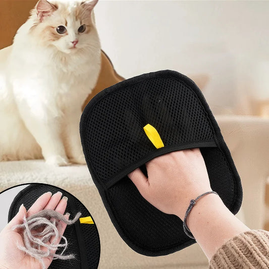 Black pet grooming tool. with a cat in the background.